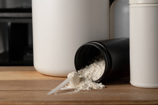 a scoop on top of a mountain of creatine powder,. muscle building concept.